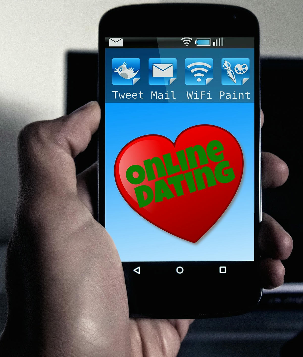 Smartphone met rood hart en de tekst “Online Dating”, symbool voor moderne liefde en authentieke connecties online.